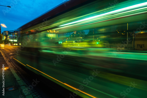 View of Bus in notion blur on the traffic on streets of Bratislava at night next to the Eurovea