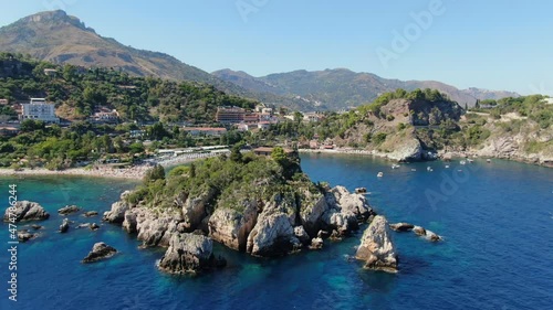 Taormina, Isola bella, Sicily. Drone flight slowly turning around the island. photo