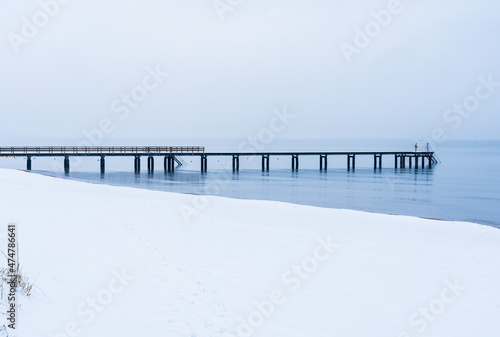 Long wooden jetty on Angelholm beach during winter on the Swedish West Coast. Selective focus. © PhotosbyPatrick