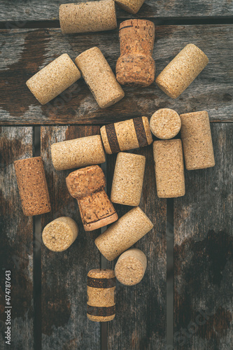 Overhead view of assorted corks on a wooden table photo