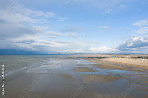 Clouds over the sandy beach of Ouistreham in Europe  France  Normandy  in summer  on a sunny day.