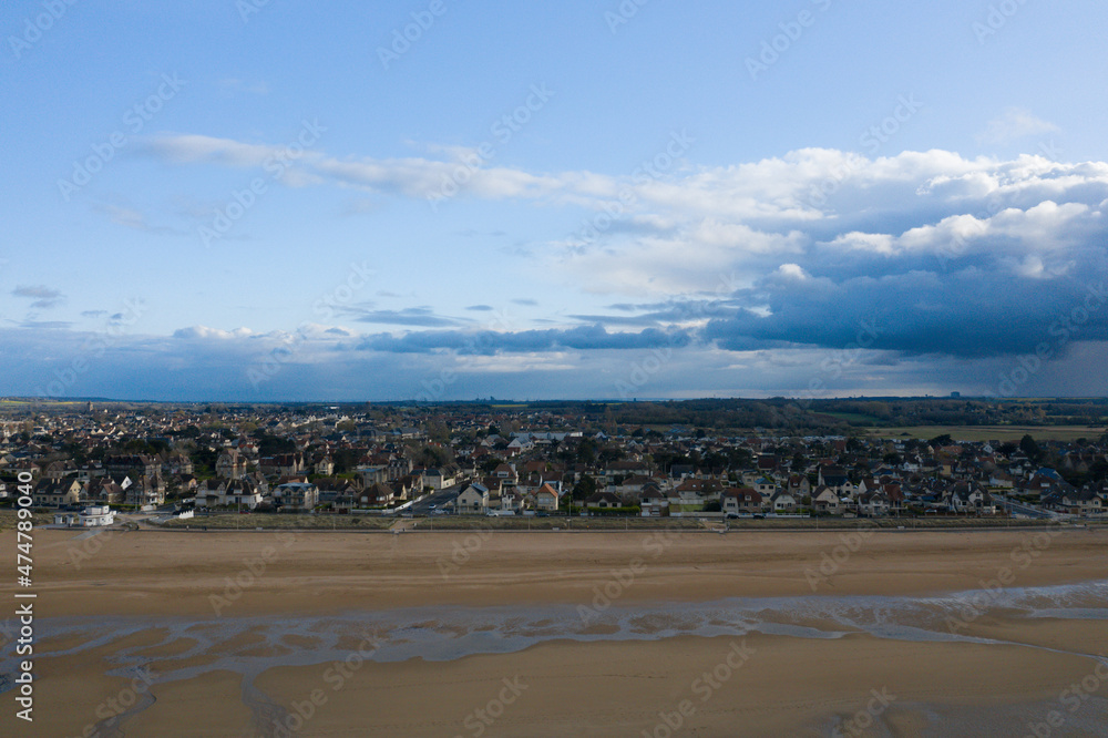 The city of Ouistreham and its beach in Europe, France, Normandy, in summer, on a sunny day. The city of Ouistreham and its beach in Europe, France, Normandy, in summer, on a sunny day.