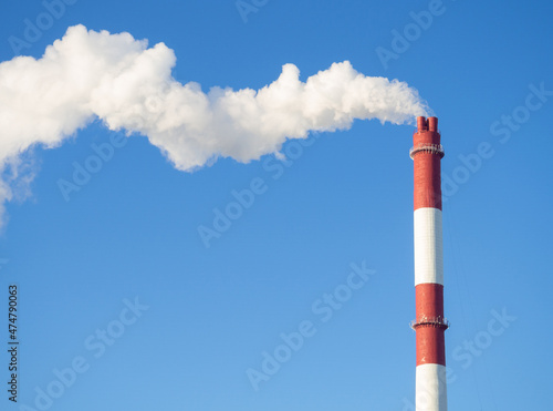 Pipes with smoke in winter. Industrial area. Unfavorable ecology.