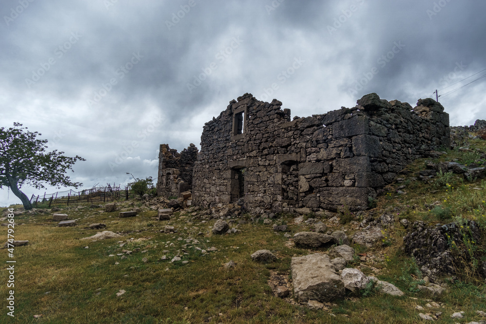 Ruins of stone house on the mountain over cloudy sky, Croatia