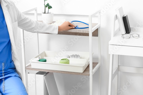 Female doctor taking stethoscope in clinic