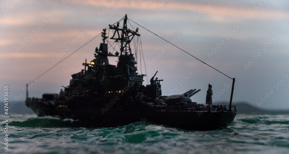 Silhouettes of a crowd standing at blurred military war ship on foggy background. Selective focus. Silhouettes of a crowd standing at blurred military war ship on foggy background. Selective focus.