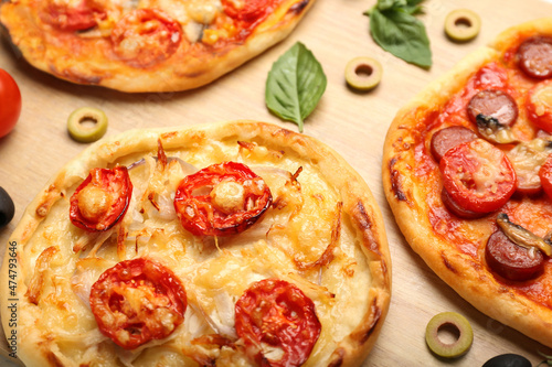 Delicious mini pizzas on wooden background  closeup