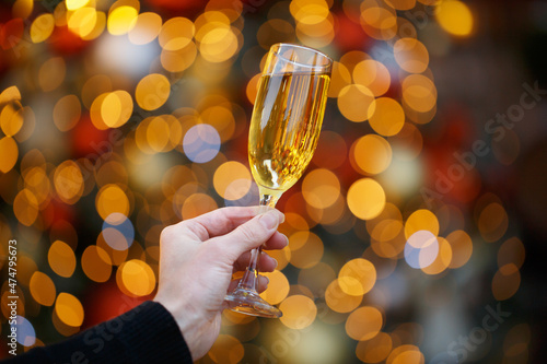 Human hands with glasses of champagne on a Christmas or New Year background
