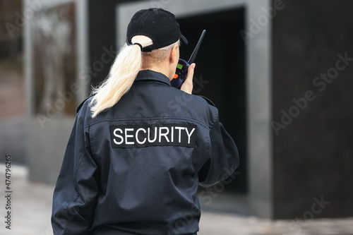 Female security guard outdoors  back view