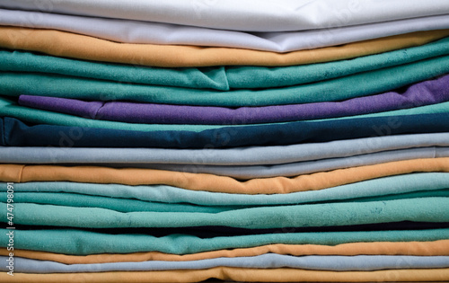 Colorful folded clothes close up.