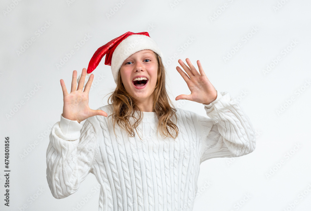 Christmas portrait of teenage girl in santa hat expression surprise Christmas portrait of teenage girl in santa hat expression surprise
