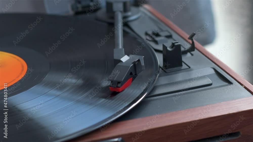 View of old record player playing music from a vinyl record View of old record player playing music from a vinyl record