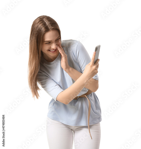 Young woman with mobile phone on white background photo