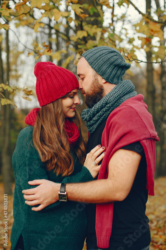 Elegant couple spend time in a autumn park