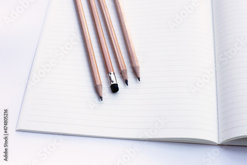 Pencils on notebooks or paper on white background
