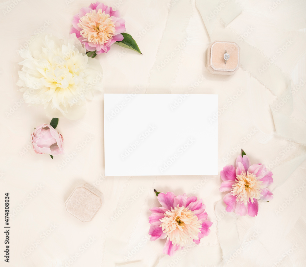 Fresh peony flower flat lay with a blank invitation card, fresh blooms and velvet ring box Fresh peony flower flat lay with a blank invitation card, fresh blooms and velvet ring box