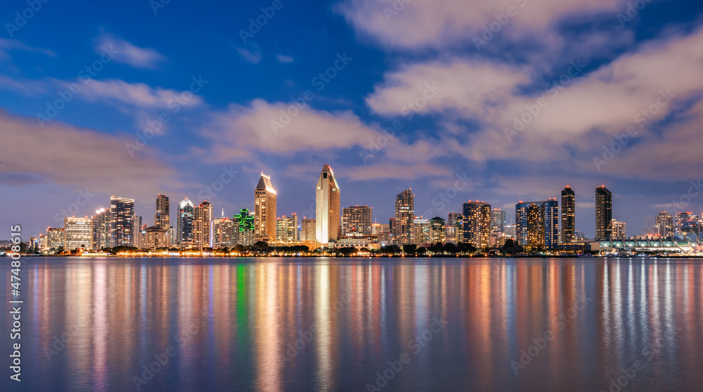 San Diego California skyline at night with reflections in water.