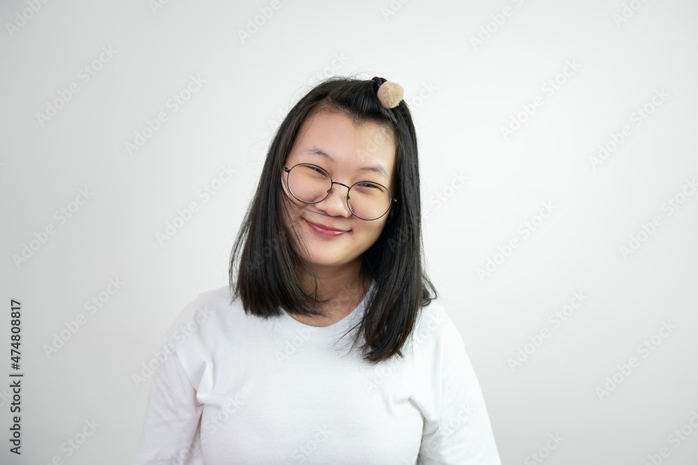 Asian Glassese Woman is looking and smiling to camera and standing on white background in studio light. Asian Glassese Woman is looking and smiling to camera and standing on white background in studio light.