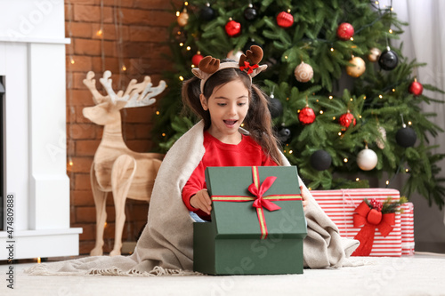 Surprised little girl openi...