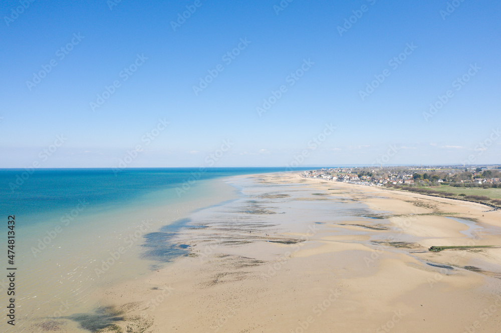 The fine sandy beach of Juno beach in Bernieres sur Mer in Europe, France, Normandy, Arromanches les Bains, in summer, on a sunny day.