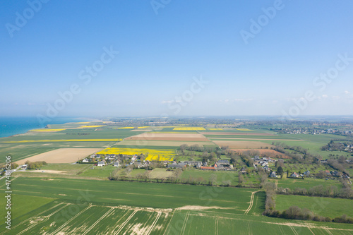 A village next to the Longues-sur-Mer battery in Europe, France, Normandy, towards Arromanches, Longues sur Mer, in spring, on a sunny day.