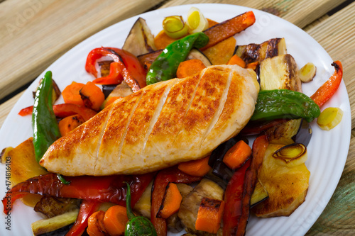 Dish of Bulgarian cuisine plakia, tasty chicken fillet and different baked vegetables photo