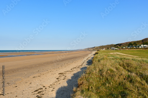 The beach of Omaha beach at the edge of the English Channel in Europe  in France  in Normandy  towards Arromanches  in Colleville  in spring  on a sunny day.
