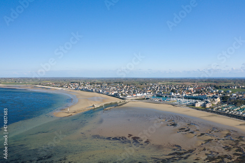 The city of Grandcamp-Maisy and the dikes of its port in Europe, France, Normandy, towards Omaha beach, in spring, on a sunny day.