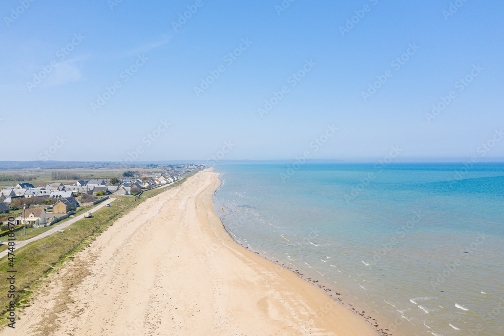 The long sandy beach of Utah Beach facing the Channel Sea in Europe, France, Normandy, Manche, in spring, on a sunny day.