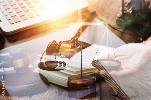 Business and lawyers discussing contract papers with brass scale on desk in office. Law, legal services, advice, justice and law concept picture with film grain effect