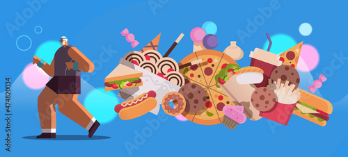 senior sportsman running away from junk food unhealthy nutrition junkfood addiction stop fast food concept