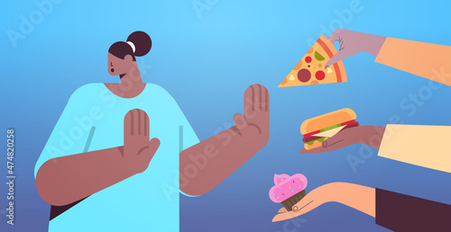 african american woman showing no stop gesture to junk food unhealthy nutrition junkfood addiction stop fast food