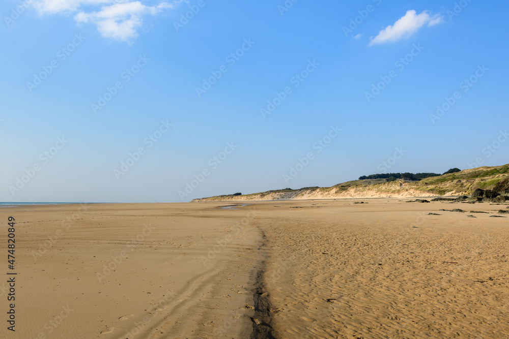 The fine sand beach of the Old Church in Europe, France, Normandy, Manche, in spring, on a sunny day.