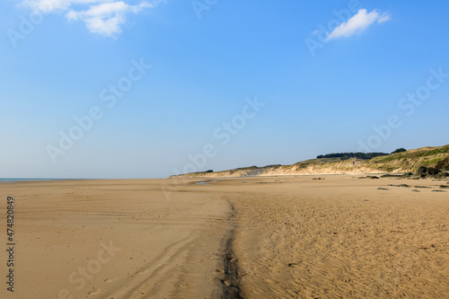 The fine sand beach of the Old Church in Europe, France, Normandy, Manche, in spring, on a sunny day.