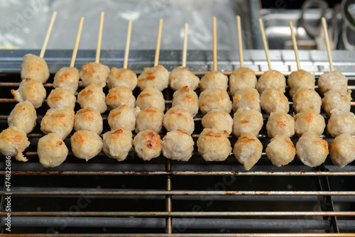 Pork Meatballs Skewers are grilled on a smokeless electric grill. (selective focus)