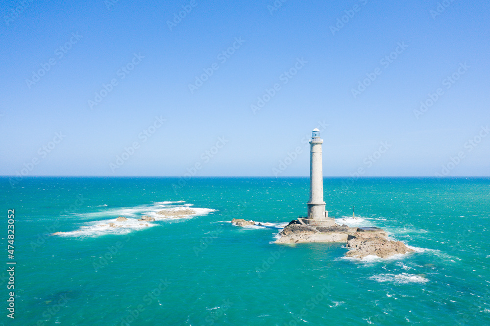 The Lighthouse of Cap de la Hague and the waves of the English Channel in Europe, France, Normandy, Manche, in spring on a sunny day.