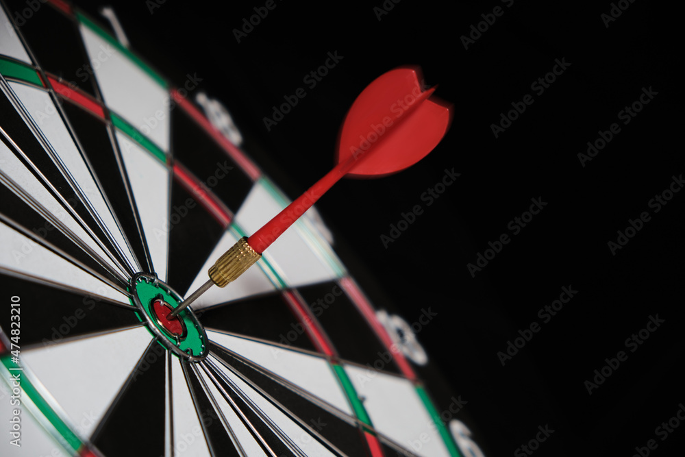 Dartboard with darts hitting exactly on target. Dartboard with darts hitting exactly on target.