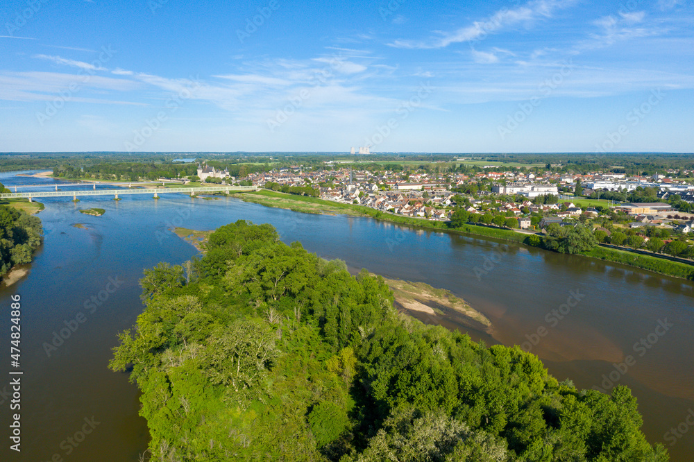 An island in the middle of the town of Sully sur Loire in Europe, in France, in the Center region, in the Loiret, in summer, on a sunny day.