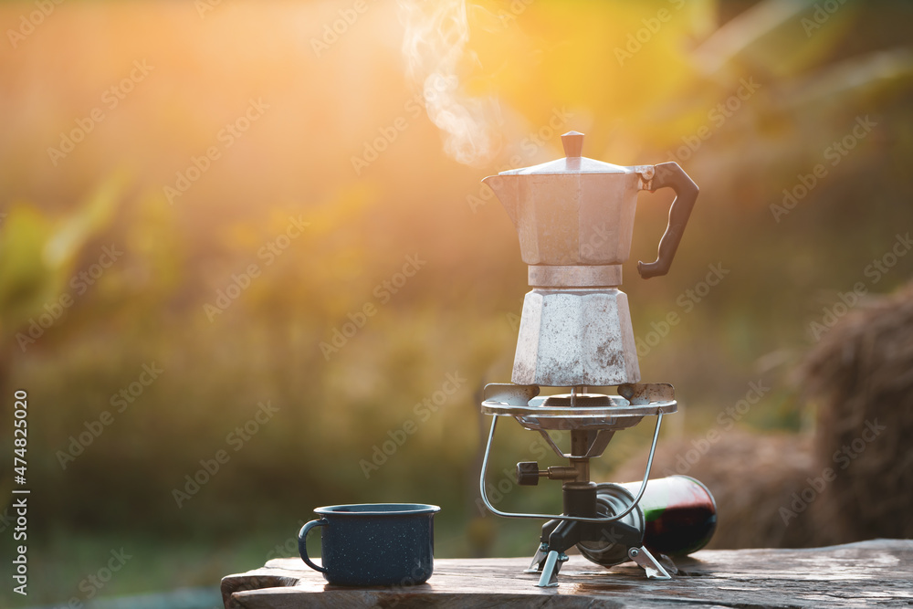 antique coffee pot On the gas stove for camping when the sun rises in the morning.soft focus. Stock Photo Adobe Stock