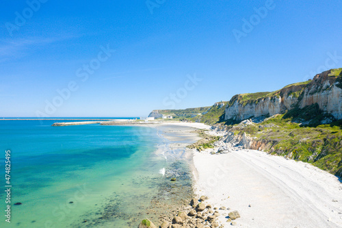The verdant Norman Cliffs above the white pebble beach in Europe  France  Normandy  towards Deauville  in summer  on a sunny day.