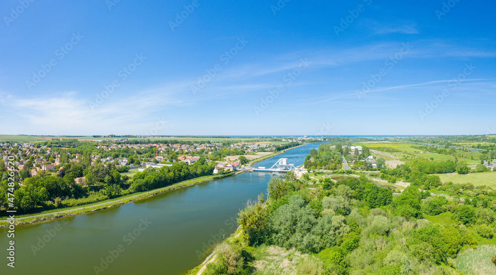 The panoramic view on the Pegasus Bridge in Europe, in France, in Normandy, towards Caen, in Ranville, in summer, on a sunny day.