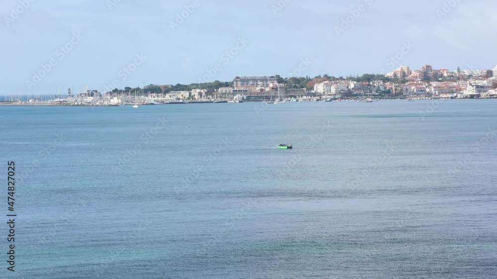wide view about some boat fishing with Cascais behind wide view about some boat fishing with Cascais behind