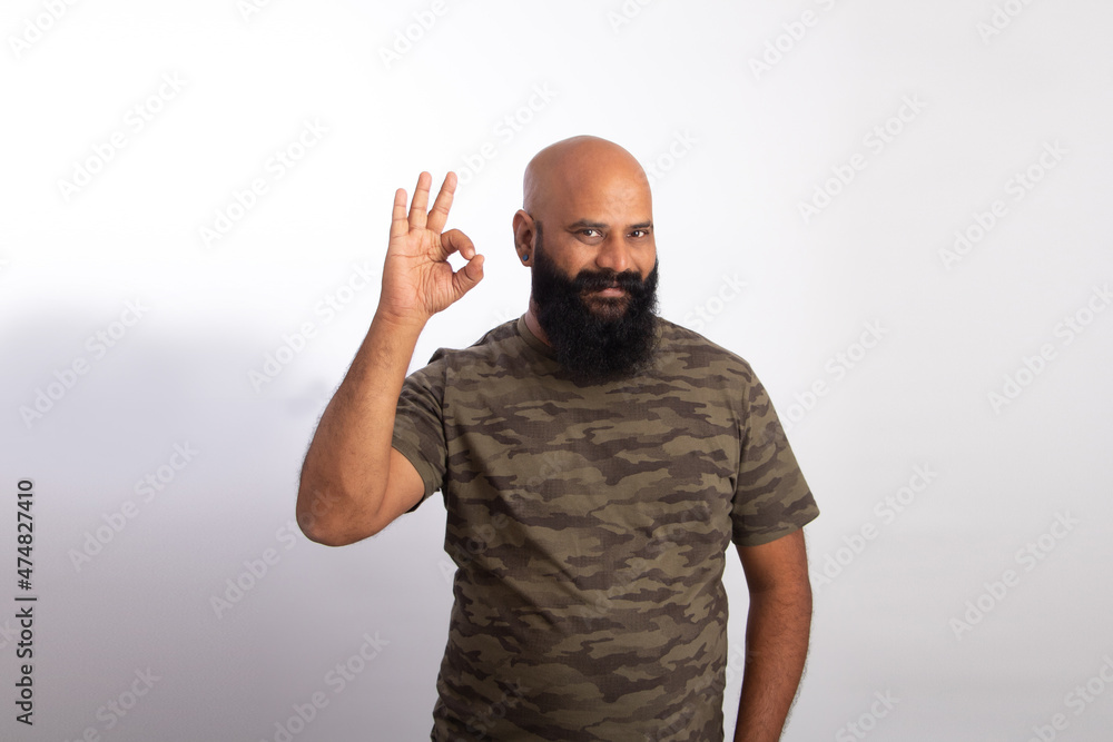 Naklejka premium Happy Indian Healthy middle aged man Showing okay gesture with hand