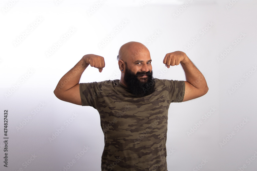 happy Indian Healthy middle aged man showing his arms and biceps happy Indian Healthy middle aged man showing his arms and biceps