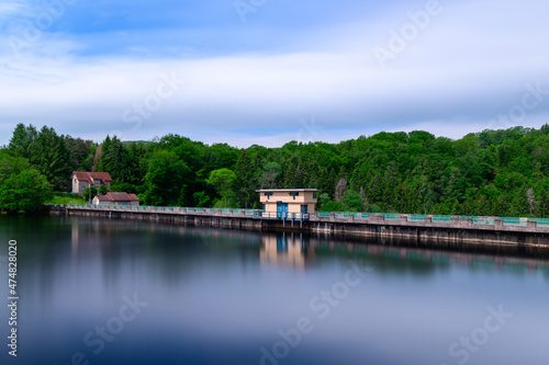 The Lac de Chaumecon dam surrounded by forest in Europe, France, Burgundy, Nievre, Morvan, in summer, on a sunny day.