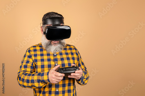 middle-aged hipster man with virtual reality glasses and game controller © jcalvera