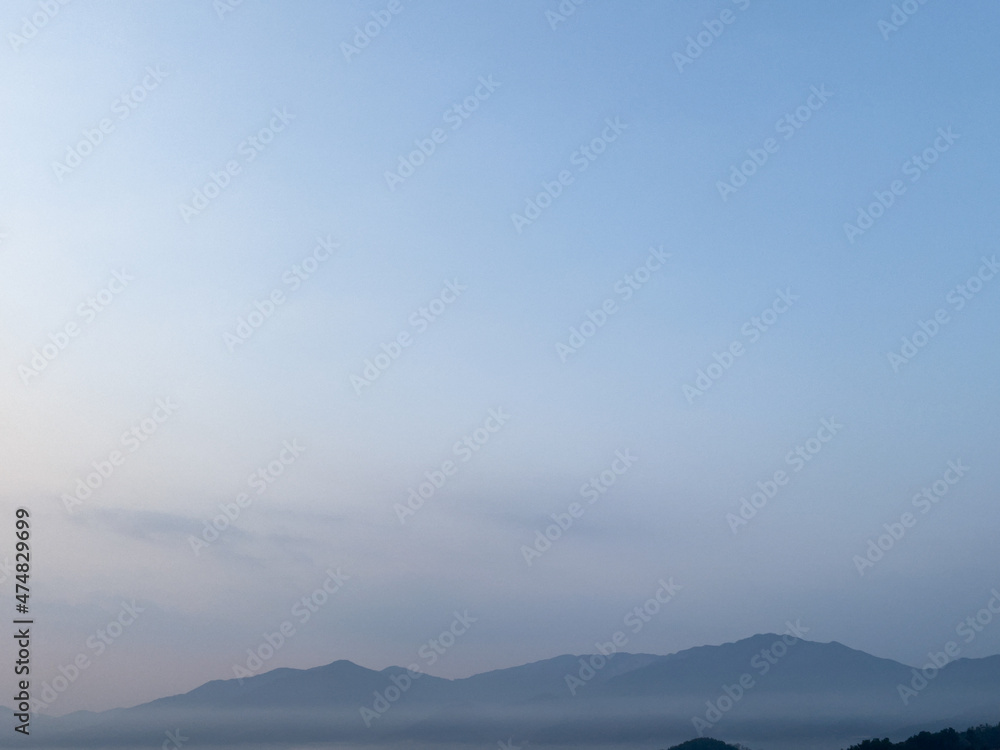 fog over the mountains at dawn in winter