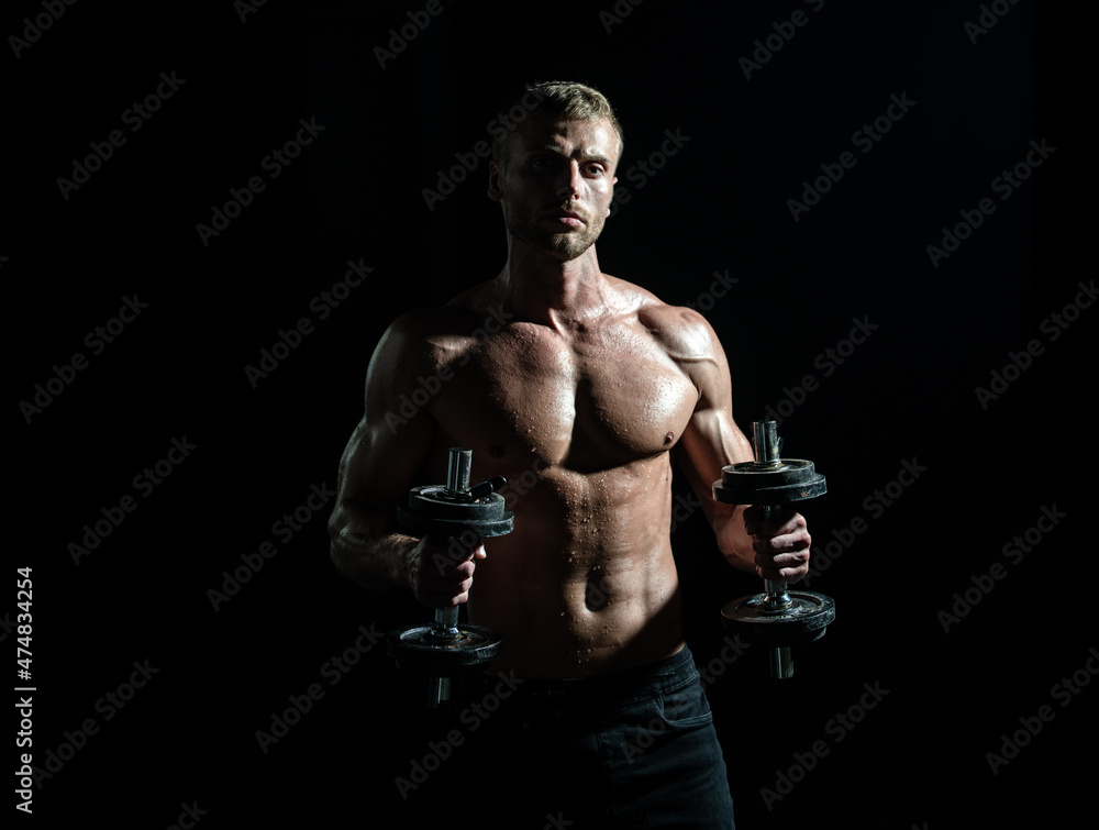 Sexy sporty torso, man with dumbbells. Muscular and strong guy exercising. Sportsman doing exercises with weights. Fitness and crossfit.