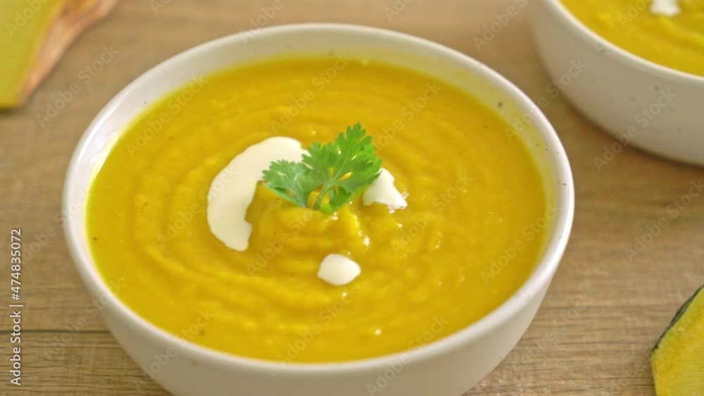 pumpkin soup in white bowl - Vegetarian and vegan food style pumpkin soup in white bowl - Vegetarian and vegan food style