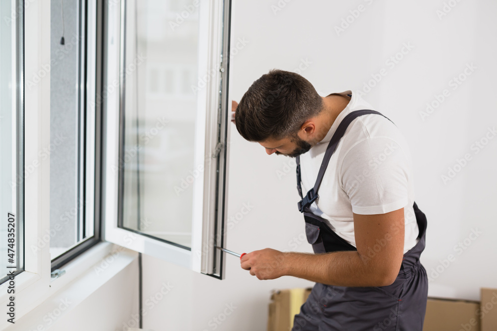 worker fixing pvc windows indoor